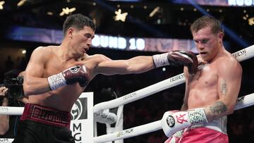 May 7, 2022; Las Vegas, Nevada, USA; Canelo Alvarez (pink trunks) and Dimitry Bivol (black trunks) box during their light heavyweight championship bout at T-Mobile Arena. Mandatory Credit: Joe Camporeale-USA TODAY Sports