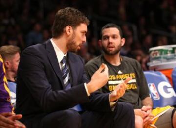 Pau Gasol charla con Jordan Farmer en el banquillo de los Lakers.