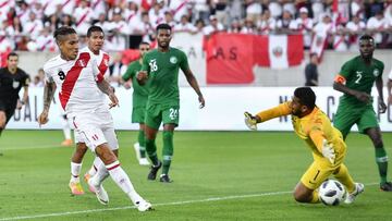 Peru's forward Paolo Guerrero (L) scores his team's second goal past Saudi Arabia's goalkeeper Abdullah Al-Mayouf during an international friendly football match between Saudi Arabia and Peru at Kybunpark stadium in St Gallen on June 3, 201