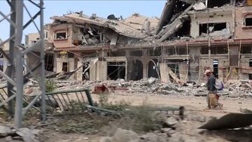 People walk past destroyed buildings, amid the ongoing conflict between Israel and Palestinian Islamist group Hamas, in Khan Younis, Gaza April 11, 2024, in this screengrab from a handout video. UN News/Handout via REUTERS    THIS IMAGE HAS BEEN SUPPLIED BY A THIRD PARTY. NO RESALES. NO ARCHIVES. MANDATORY CREDIT