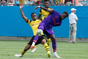 Liverpool's Divock Origi (R) vies for the ball with Borussia Dortmund's Abdou Diallo (L) during the 2018 International Champions Cup at Bank of America Stadium in Charlotte, North Carolina, on July 22, 2018. / AFP PHOTO / JIM WATSON