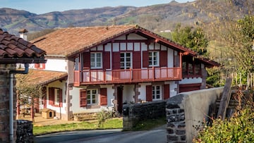 A large house surrounded by mountains and trees