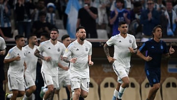 Argentina's forward #10 Lionel Messi (3rdR) and his teammates warm up ahead of the start of the Qatar 2022 World Cup final football match between Argentina and France at Lusail Stadium in Lusail, north of Doha on December 18, 2022. (Photo by Paul ELLIS / AFP)