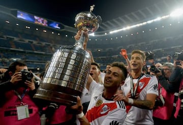 River Plate's Gonzalo Martinez holds up the Copa Libertadores trophy after victory in the 2018 Copa Libertadores final soccer match between River Plate and Boca Juniors at the Santiago Bernabeu stadium.