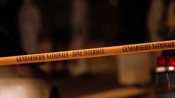 This photograph taken on December 17, 2020 shows a gendarmerie tape as French gendarmes and forensic officers work next to cars as the road is blocked in Domont, north of Paris where an armed man entrenched with his wife was found dead after reportedly having shot and wounded at least two people. (Photo by GEOFFROY VAN DER HASSELT / AFP)