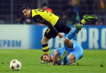 El jugador del Dortmund Robert Lewandowski (i) disputa el balón con Christian Maggio (d), del Nápoles, durante el partido del grupo F de la Liga de Campeones en, Dortmund (Alemania).