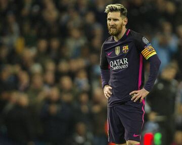 Lionel Messi stands on the pitch after Barcelona's defeat at the hands of Manchester City