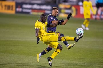 Nov 29, 2020; Columbus, Ohio, USA; Columbus Crew SC defender Jonathan Mensah (4) clears the ball from an attacking Nashville SC midfielder Hany Mukhtar (10) in the second half at MAPFRE Stadium. Mandatory Credit: Trevor Ruszkowski-USA TODAY Sports