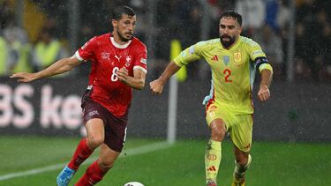 Switzerland's midfielder Remo Freuler (L) fights for the ball with Spain's defender Dani Carvajal during the UEFA Nations League football match between Switzerland and Spain at Geneva stadium in Geneva, on September 8, 2024. (Photo by Fabrice COFFRINI / AFP)