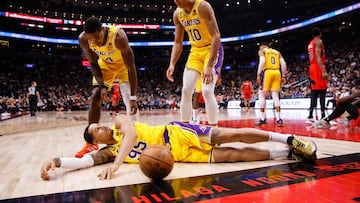 TORONTO, ON - DECEMBER 07: Lonnie Walker IV #4 and Max Christie #10 look down at Juan Toscano-Anderson #95 of the Los Angeles Lakers after he grabs a loose ball against the Toronto Raptors during the first half of their NBA game at Scotiabank Arena on December 7, 2022 in Toronto, Canada. NOTE TO USER: User expressly acknowledges and agrees that, by downloading and or using this photograph, User is consenting to the terms and conditions of the Getty Images License Agreement.   Cole Burston/Getty Images/AFP (Photo by Cole Burston / GETTY IMAGES NORTH AMERICA / Getty Images via AFP)