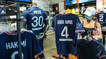 Jerseys of Paris Saint-Germain players Achraf Hakimi, Sergio Ramos and Lionel Messi on display for sale at the official PSG store in the Champs Elysee avenue in Paris.
