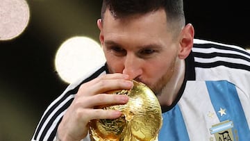 FILE PHOTO: Soccer Football - FIFA World Cup Qatar 2022 - Final - Argentina v France - Lusail Stadium, Lusail, Qatar - December 18, 2022 Argentina's Lionel Messi kisses the trophy as he celebrates winning the World Cup REUTERS/Carl Recine/File Photo