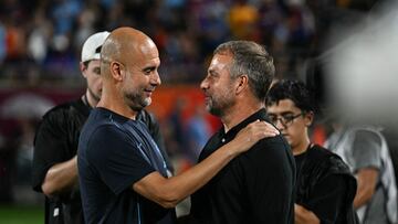 (L-R) Manchester City manager Pep Guardiola greets FC Barcelona manger Hansi Flick during the 2024 FC Series pre-season friendly football match between FC Barcelona and Manchester City at Camping World Stadium in Orlando, Florida, on July 30, 2024. (Photo by CHANDAN KHANNA / AFP)