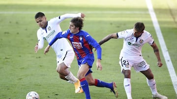 EIBAR, SPAIN - NOVEMBER 22: Álex Pozo of Eibar(C) is tackled by Cucho Hernández of Getafe(L) and Damián Suárez of Getafe(R) during the La Liga Santader match between SD Eibar and Getafe CF at Estadio Municipal de Ipurua on Nove