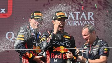 (L-R) Winner Red Bull Racing's Dutch driver Max Verstappen, third placed Red Bull Racing's Mexican driver Sergio Perez and Red Bull Racing chief engineer Paul Monaghan celebrate on the podium with Champagne after the Formula One Hungarian Grand Prix at the Hungaroring race track in Mogyorod near Budapest on July 23, 2023. (Photo by ATTILA KISBENEDEK / AFP)