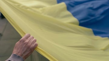 A protester hold a giant Ukrainian flag during a rally against Russia&#039;s military invasion on Ukraine, in Belgrade on March 20, 2022. 