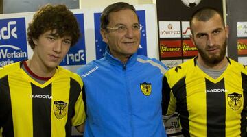 Beitar Jerusalem F.C. soccer coach Eli Cohen, center, poses for the media with new Beitar players Gabriel Kadiev, left, and Zaur Sadayev, right, during a press conference in Jerusalem, Wednesday, Jan. 30, 2013. The arrival of Zaur Sadayev and Gabriel Kadi