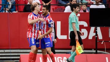 Atletico Madrid's Spanish midfielder #08 Pablo Barrios (L) celebrates with Atletico Madrid's Spanish midfielder #06 Koke after scoring his team's second goal during the Spanish league football match between Sevilla FC and Club Atletico de Madrid at the Ramon Sanchez Pizjuan stadium in Seville on April 6, 2025. (Photo by CRISTINA QUICLER / AFP)