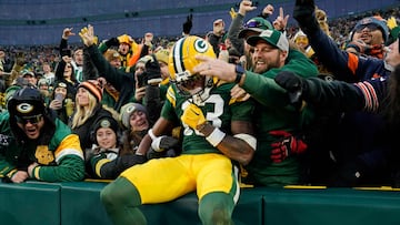 GREEN BAY, WISCONSIN - JANUARY 07: Dontayvion Wicks #13 of the Green Bay Packers celebrates after a touchdown with fans during the second quarter in the game against the Chicago Bears at Lambeau Field on January 07, 2024 in Green Bay, Wisconsin. Patrick McDermott/Getty Images/AFP (Photo by Patrick McDermott / GETTY IMAGES NORTH AMERICA / Getty Images via AFP)
