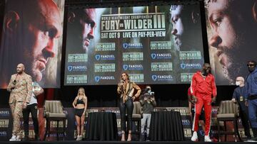 LAS VEGAS, NEVADA - OCTOBER 06: Broadcaster Kate Abdo (C) moderates a news conference for WBC heavyweight champion Tyson Fury (L) and Deontay Wilder (3rd R) at MGM Grand Garden Arena on October 6, 2021 in Las Vegas, Nevada. Fury will defend his title agai