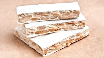 Classic Hard Spanish Turron on White BackgroundThis traditional dessert is very popular in Spain and Latinamerica in Christmas time and New Years eve celebrations