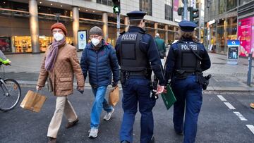 Police officers walk along a shopping street as they check the coronavirus disease (COVID-19) protocol in Dresden, Germany, November 23, 2021. REUTERS/Matthias Rietschel