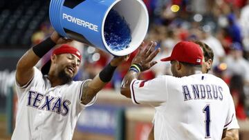 Jun 20, 2016; Arlington, TX, USA; Texas Rangers second baseman Rougned Odor (12) prepares to douse shortstop Elvis Andrus (1) following their win over the Baltimore Orioles during a baseball game at Globe Life Park in Arlington. The Rangers won 4-3. Mandatory Credit: Jim Cowsert-USA TODAY Sports