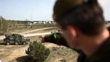 A soldier of the NATO Response Force (NRF) points his finger at a military vehicle as he attends a Norwegian, Czech, and German combat exercise during a press day as part of the "Quadriga 2024" training in Gardelegen, Germany, April 8, 2024. REUTERS/Liesa Johannssen