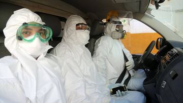 An ambulance crew attired in full protection gear waits at the Cesar Garayar support hospital emergency in the city of Iquitos, in the Amazon basin, dedicated to endemic diseases like dengue, malaria, chikunguya and leptospirosis on May 22, 2020, which still affect the population in addition to the arrival of the novel coronavirus that has claimed the lives of 14 doctors in the hospital. - Focused attention on fighting the new coronavirus in Peru has detracted the ability to combat the dengue fever, an explosive situation in the Amazon region, where it is leaving a trail of disease and death in cities and remote indigenous villages. (Photo by Cesar Von BANCELS / AFP)