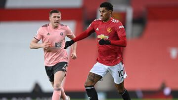 Manchester United's English striker Marcus Rashford (R) runs with the ball chased by Sheffield United's English midfielder John Lundstram (L) during the English Premier League football match between Manchester United and Sheffield United at Old