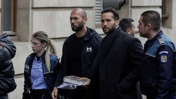 Andrew Tate and his brother Tristan are escorted by police officers outside the headquarters of the Bucharest Court of Appeal, in Romania.