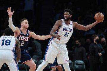 Dec 16, 2021; Brooklyn, New York, USA; Philadelphia 76ers center Joel Embiid (21) shields the ball during the second half as Brooklyn Nets forward Blake Griffin (2) defends at Barclays Center. Mandatory Credit: Vincent Carchietta-USA TODAY Sports