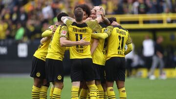 DORTMUND, GERMANY - OCTOBER 02: Julian Brandt of Borussia Dortmund (obscured) celebrates with teammates after scoring their team&#039;s second goal during the Bundesliga match between Borussia Dortmund and FC Augsburg at Signal Iduna Park on October 02, 2