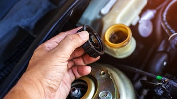 Un conductor revisa el líquido de frenos de su auto