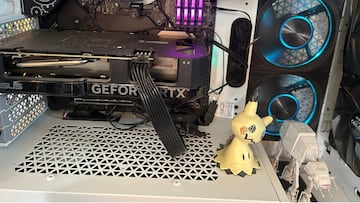 Close-up of an Nvidia GeForce RTX 4060 seated in a custom PC build, illuminated by RGB lighting.