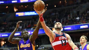 Feb 2, 2017; Washington, DC, USA; Los Angeles Lakers forward Luol Deng (9) and Washington Wizards center Marcin Gortat (13) reach for a rebound during the second half at Verizon Center. Washington Wizards won 116 - 108. Mandatory Credit: Brad Mills-USA TODAY Sports