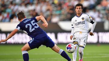 Jul 30, 2023; Carson, CA, USA; Los Angeles Galaxy midfielder Riqui Puig (6) moves the ball against Vancouver Whitecaps midfielder Ryan Gauld (25) during the second half at Dignity Health Sports Park. Mandatory Credit: Gary A. Vasquez-USA TODAY Sports