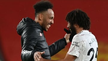 Arsenal's Gabonese striker Pierre-Emerick Aubameyang (L) celebrates with Arsenal's Egyptian midfielder Mohamed Elneny (R) at the end of the English Premier League football match between Manchester United and Arsenal at Old Trafford in Manchester