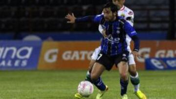 Francisco Arrué protege el balón ante Iván Vásquez en el partido contra Audax Italiano. El volante estará un largo período inactivo.