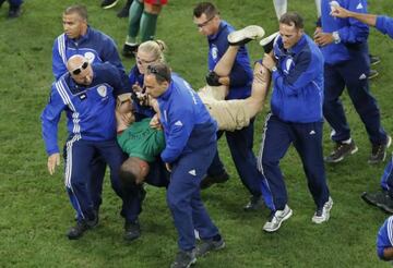 Pitch invader Shamshir Karimi carried from the field of play.