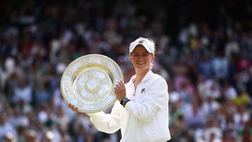 Czech Republic's Barbora Krejcikova poses with the winner's trophy, the Venus Rosewater Dish, after winning against Italy's Jasmine Paolini during their women's singles final tennis match on the thirteenth day of the 2024 Wimbledon Championships at The All England Lawn Tennis and Croquet Club in Wimbledon, southwest London, on July 13, 2024. Krejcikova won the match 6-2, 2-6, 6-4. (Photo by HENRY NICHOLLS / AFP) / RESTRICTED TO EDITORIAL USE
