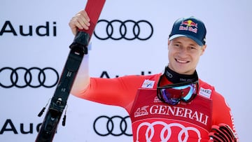 Third placed Switzerland's Marco Odermatt celebrates on the podium after the Men's Downhill event of the FIS Alpine World Cup in Courchevel, French Alps, on March 13, 2026. (Photo by Olivier CHASSIGNOLE / AFP)