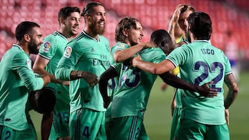 Real Madrid&#039;s French defender Ferland Mendy (3R) celebrates with teammates after scoring  during the Spanish league football match Granada FC vs Real Madrid CF at Nuevo Los Carmenes stadium in Granada on July 13, 2020. (Photo by JORGE GUERRERO / AFP)