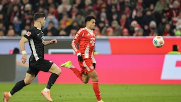 Bayern Munich's Colombian forward #14 Luis Diaz (R) and Wolfsburg's Greek defender #04 Konstantinos Koulierakis vie for the ball during the German first division Bundesliga football match between FC Bayern Munich and VfL Wolfsburg in Munich, southern Germany, on January 11, 2026. (Photo by Alexandra BEIER / AFP) / DFL REGULATIONS PROHIBIT ANY USE OF PHOTOGRAPHS AS IMAGE SEQUENCES AND/OR QUASI-VIDEO