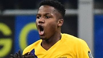 Barcelona&acute;s Guinea-Bissau forward Ansu Fati (Top) celebrates after scoring  during the UEFA Champions League Group F football match Inter Milan vs Barcelona on December 10, 2019 at the San Siro stadium in Milan. (Photo by Miguel MEDINA / AFP)