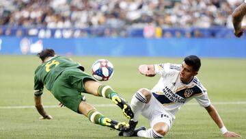 CARSON, CALIFORNIA - MARCH 31: Diego Valeri #8 of Portland Timbers falls as Joe Corona #14 of the Los Angeles Galaxy goes after the ball during the first half at Dignity Health Sports Park on March 31, 2019 in Carson, California.   Katharine Lotze/Getty Images/AFP
 == FOR NEWSPAPERS, INTERNET, TELCOS &amp; TELEVISION USE ONLY ==