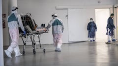 VERDUNO, ITALY - MARCH 31: Personal healthcare workers with Personal Protective Equipment (PPE) transport infected Coronavirus (COVID 19) patients at the Verduno Hospital on March 31, 2020 in Verduno, Italy. The Italian government continues to enforce the
