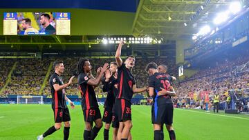 Barcelona's Brazilian forward #11 Raphinha (R) celebrates with teammates after scoring his team's fourth goal during the Spanish league football match between Villarreal CF and FC Barcelona at La Ceramica stadium in Vila-real, on September 22, 2024. (Photo by JOSE JORDAN / AFP)