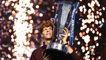 TOPSHOT - Italy's Jannik Sinner lifts the trophy after winning over Spain's Carlos Alcaraz at the end of the men's single final match at the ATP Finals tennis tournament, in Turin, on November 16, 2025. (Photo by Marco BERTORELLO / AFP)
