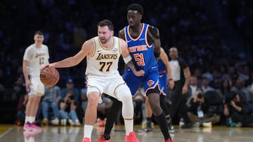 Los Angeles Lakers guard Luka Doncic (77) dribbles against New York Knicks forward Mohamed Diawara (51) in the first half at Crypto.com Arena.